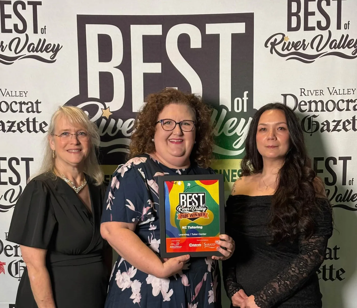 Three KC Tutoring team members holding the Best of the River Valley 2026 Winner plaque for Learning / Tutor Center